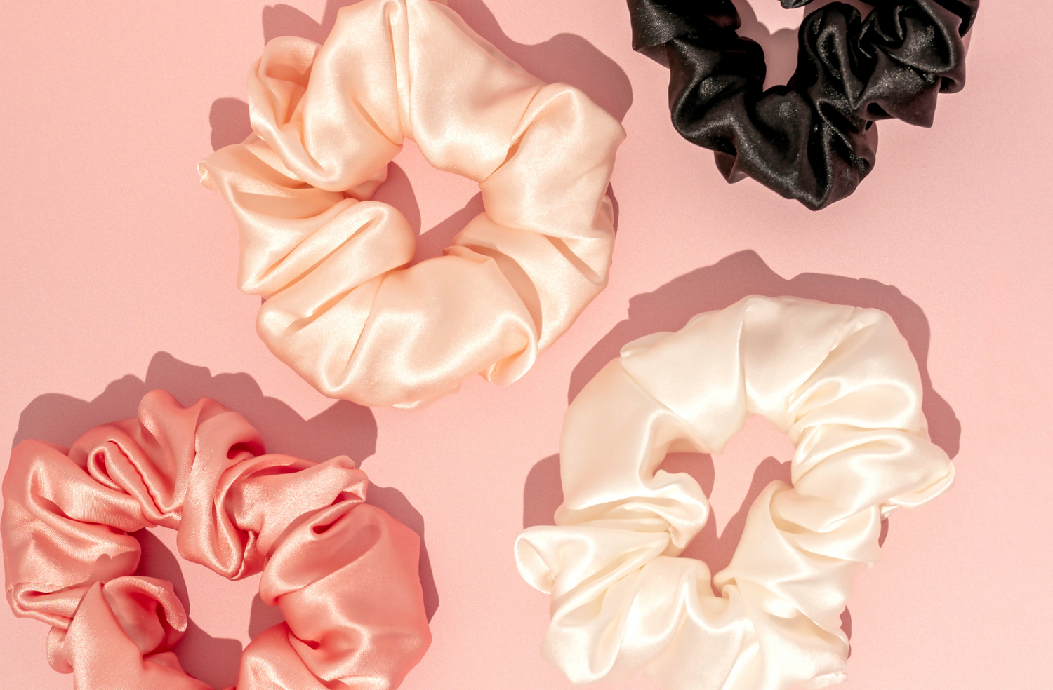 silk scrunchies on pink background